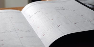 paper planner open to a blank calendar page
