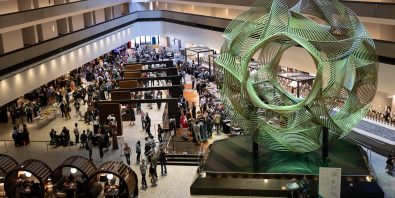 Photo of inside of an atrium with a crowd of people.