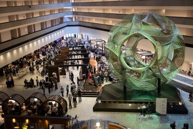 Photo of inside of an atrium with a crowd of people.